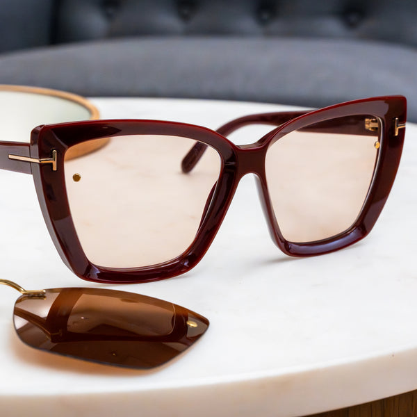 Brown sunglasses with gold accents on a white surface and Chemistrie magnets installed