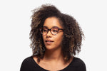 Purple Allison eyeglasses by Chemistrie worn by female model, side view