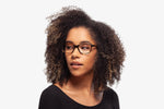 Emerald Tortoise eyeglasses by Chemistrie worn by female model, side view