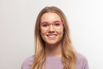 Pink Charlie eyeglasses by Chemistrie worn by female model, front view