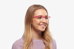 Pink Charlie eyeglasses by Chemistrie worn by female model, side view