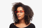 Red Charlie eyeglasses by Chemistrie worn by female model, side view