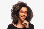 Red Charlie eyeglasses by Chemistrie worn by female model, front view