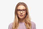 Purple Tortoise Harper eyeglasses by Chemistrie worn by female model, front view