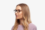 Black Laura eyeglasses by Chemistrie worn by female model, side view
