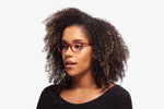 Raspberry Milan eyeglasses by Chemistrie worn by female model, side view