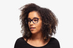 Blue Tanner eyeglasses by Chemistrie worn by female model, side view