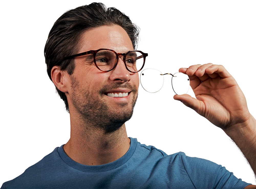 A man holding a Chemistrie magnetic clip in front of his glasses